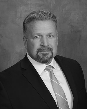 Black and white portrait photo of Dr. Cass in a suit and tie