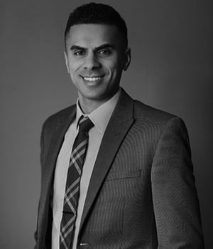 Black and white headshot of Dr. Desai in a dapper suit and die