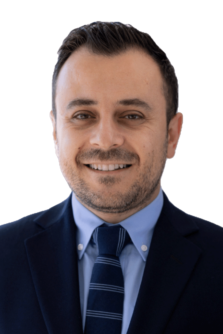 Black and white headshot of orthodontist Dr. Ankah smiling in a suit and tie