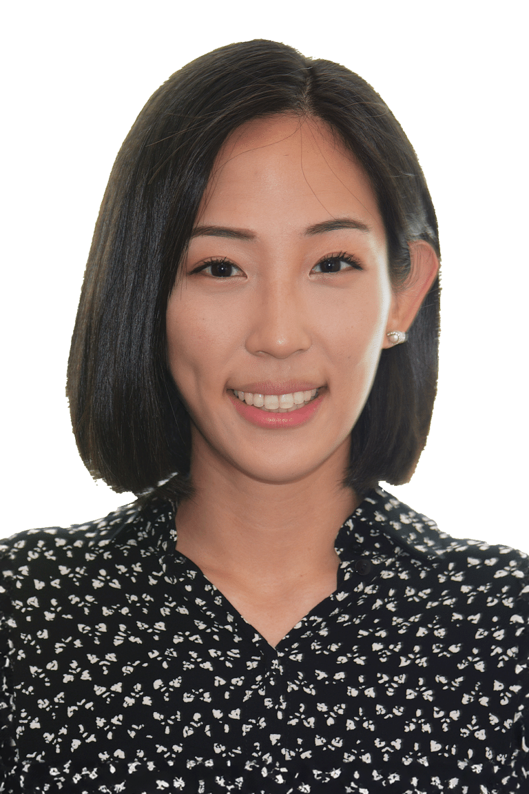 Black and white image of Dr. Le smiling with pearl earrings and a dark patterned shirt