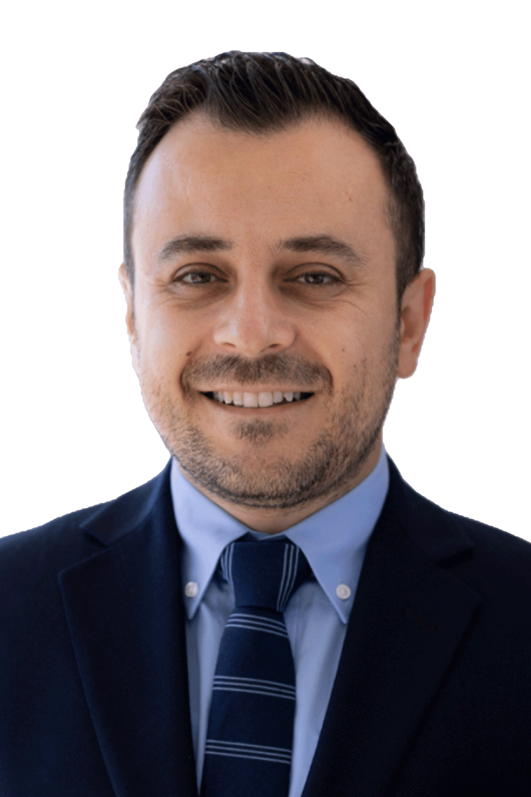 Black and white headshot of orthodontist Dr. Ankah smiling in a suit and tie.