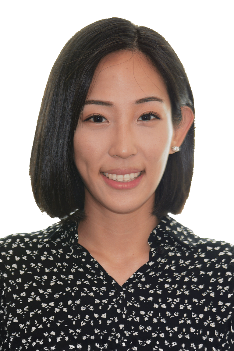 Black and white image of Dr. Le smiling with pearl earrings and a dark patterned shirt