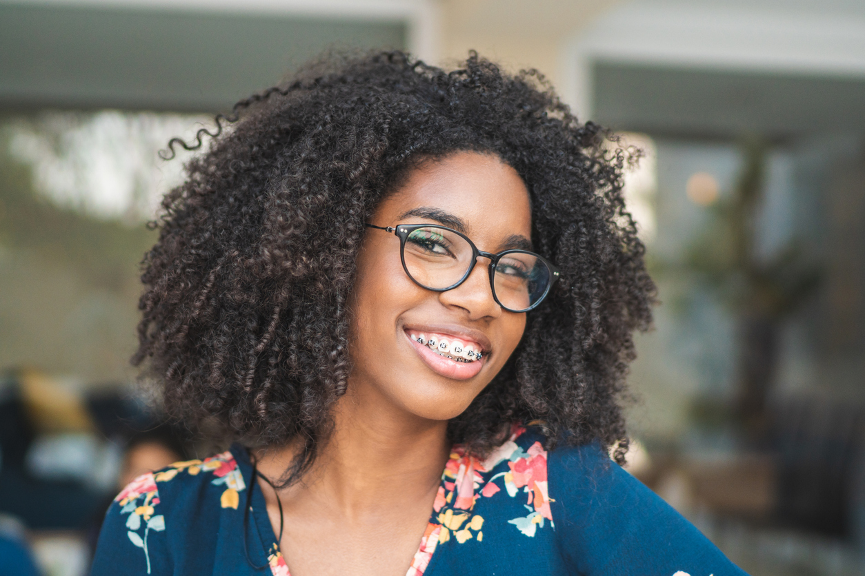 Teen smiling while showing off her braces