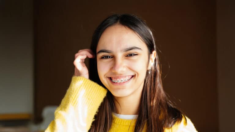 Teen with braces in Stratford, CT smiling in the afternoon sun