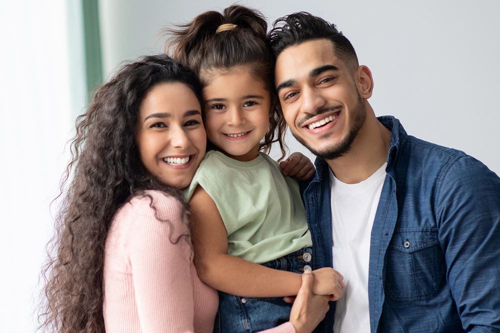 Family smiling after receiving orthodontic treatment at CT Braces