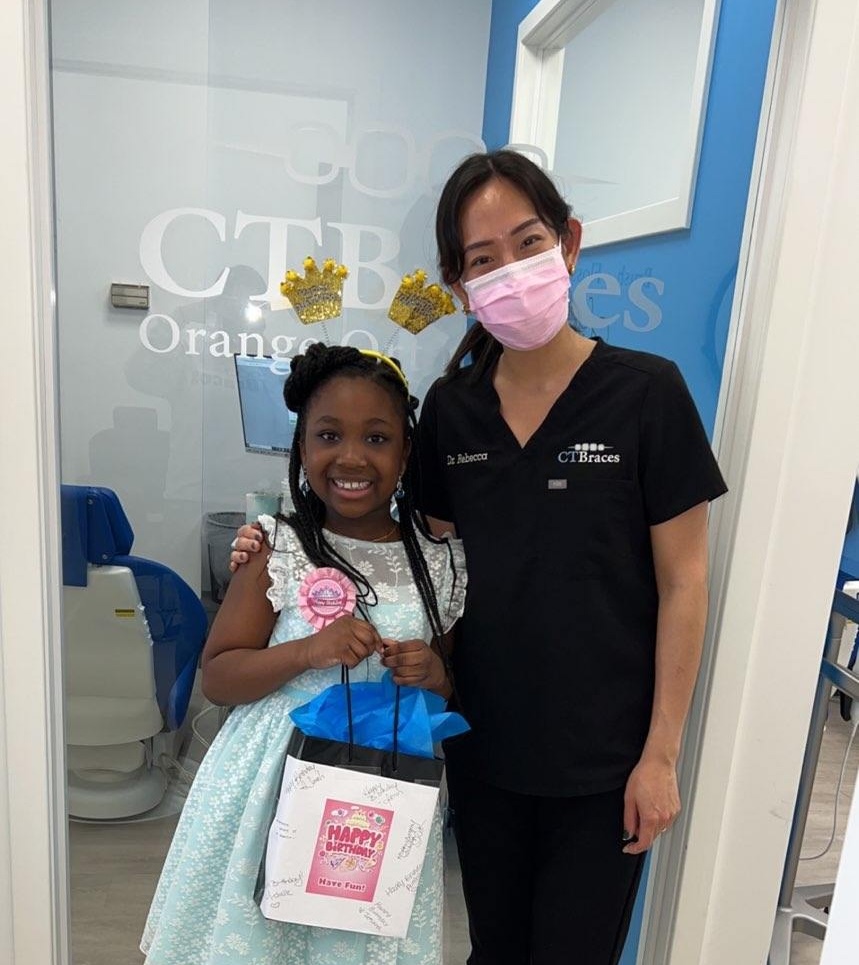 Expert Orange, CT Orthodontist Dr. Rebecca Lee smiling with a young patient on their birthday